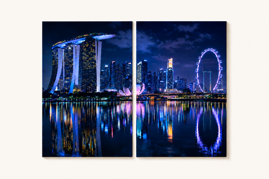 2 Panel Singapore skyline at night with illuminated buildings and reflections on water.