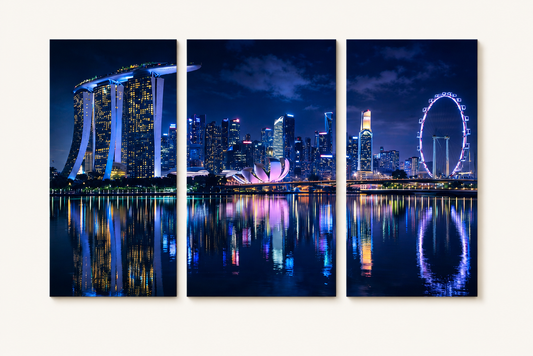 3 Panel artwork of a city skyline at night with illuminated buildings and reflections.