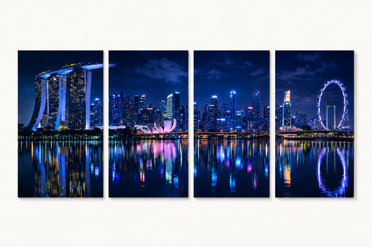 4 Panel Panoramic view of a city skyline at night with illuminated buildings and reflections on water.